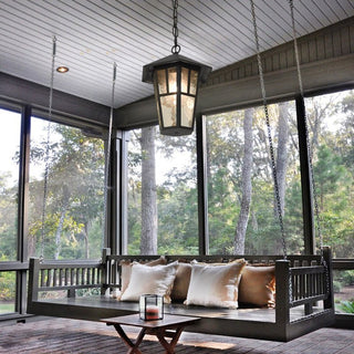 Outdoor waterproof black chandelier hanging on a covered patio