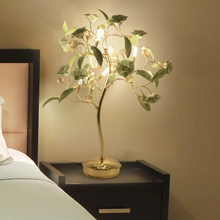 La Tour-de-Peilz tree-shaped table lamp lit beside a bed