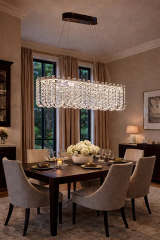Rectangular crystal chandelier hung above a long dining table, sized to the table length