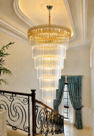 Multi-tier crystal cascade chandelier lighting a staircase landing