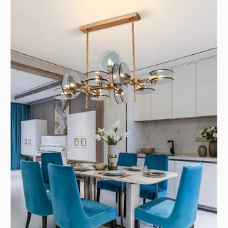 Escragnolles gold branching chandelier with glass globes above a dining table
