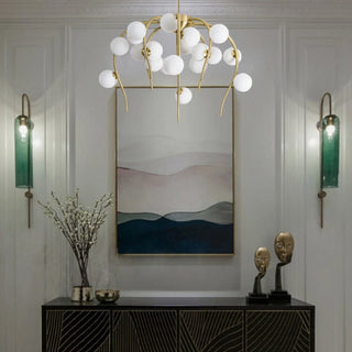 Acri gold jellyfish-shaped chandelier with glass balls above a console in an entryway