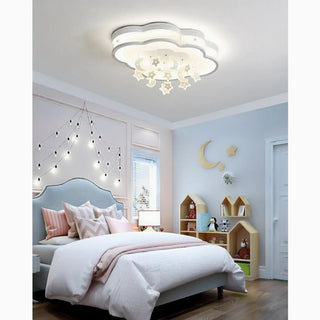 Aglie star-shaped LED ceiling light with star and moon pendants above a child's bed