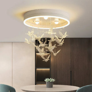 Nursery ceiling light with golden birds in a white finish, mounted on a flat ceiling