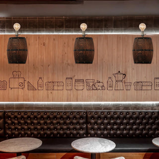Wine barrel wall lamps mounted above a bar seating area