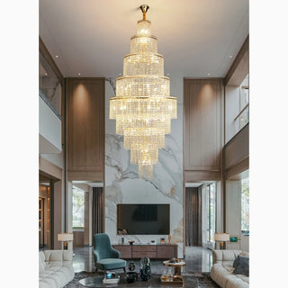 Large crystal chandelier hanging in a double-height living room with a staircase