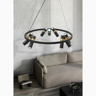 Black round ring chandelier with gold accents hanging over a living room sofa