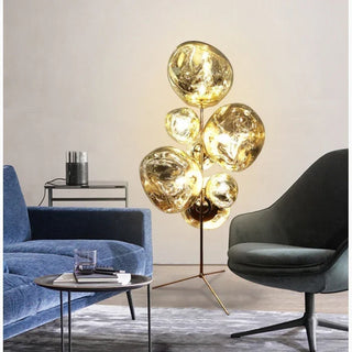 Gold lava-stone-textured floor lamp glowing in a living room corner