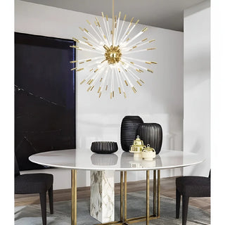 Oletta gold dandelion chandelier above a round marble dining table