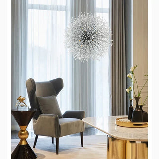 Crystal starburst chandelier over a lounge seating area in a hotel lobby