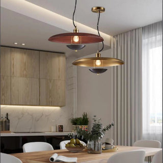 Seborga pendant lamps in gold and copper-red hanging over a dining table