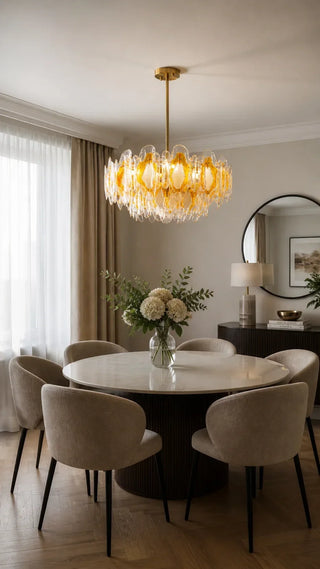Amber textured glass chandelier hanging above a round dining table