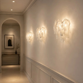 Bright hallway with warm wall sconces lighting a long corridor with wainscoting by Mirodemi