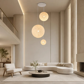 Minimalist globe pendant lights hanging in a clean, uncluttered living room with neutral tones