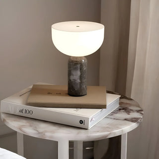 White globe table lamp with marble base on a marble side table