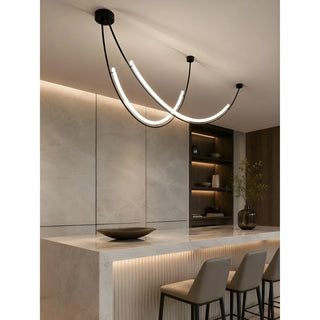 Contemporary sculptural pendant light over a kitchen island with mixed materials and integrated LED