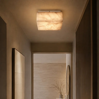 Square flush mount ceiling light illuminating a narrow home hallway