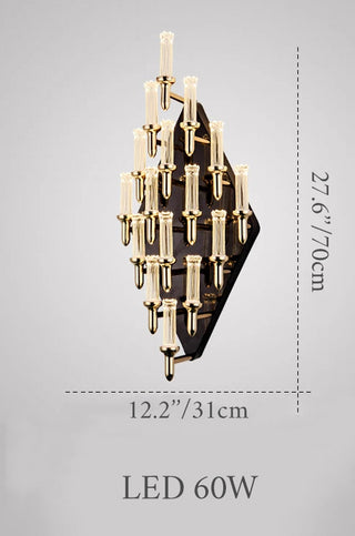Close-up of the candle-shaped gold wall lamp