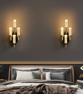 Elegant gold wall lamp with a flickering candle-style bulb