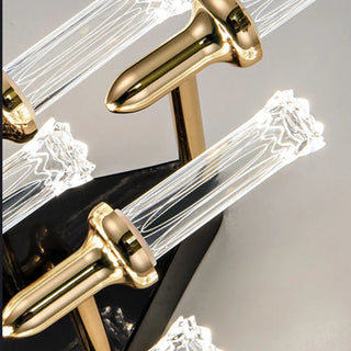 Gold metal wall lamp casting an upward warm glow
