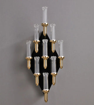 Candle-shaped gold wall light for an entryway