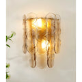 Single amber glass wall light sconce with textured circular glass design.