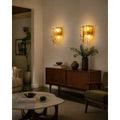 Two amber glass wall lights installed in a modern living room, creating a warm, inviting ambiance.
