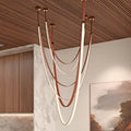 Contemporary Aurelia chandelier with warm LED glow and flexible leather suspension, ideal for double-height living rooms
