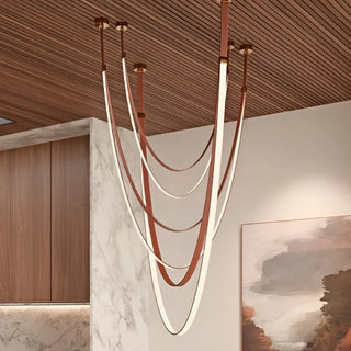 Contemporary Aurelia chandelier with warm LED glow and flexible leather suspension, ideal for double-height living rooms