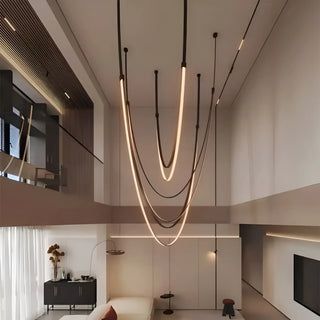 Artistic Aurelia chandelier combining golden mounts and layered leather straps for a sculptural modern look