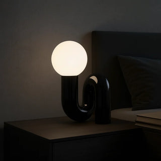Black resin sculptural lamp on bedside table – elegant modern lighting accent for minimalist interiors