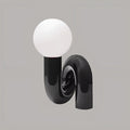 Black sculptural resin table lamp with frosted glass globe – modern artistic bedside lighting by MIRODEMI