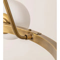 Close-up view of the brass chandelier’s frame connection, showcasing the elegant design and smooth finish.