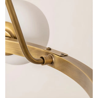 Close-up view of the brass chandelier’s frame connection, showcasing the elegant design and smooth finish.