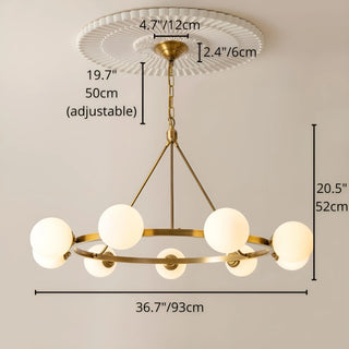 A brass chandelier with adjustable length and six white milk glass spheres, dimensions marked for easy reference