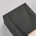Close-up image showing the textured matte black finish and sharp lines of the aluminum lamp housing.