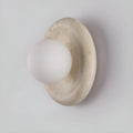 Detailed view of a compact stone wall sconce with a frosted glass globe, showing its clean lines and subtle elegance