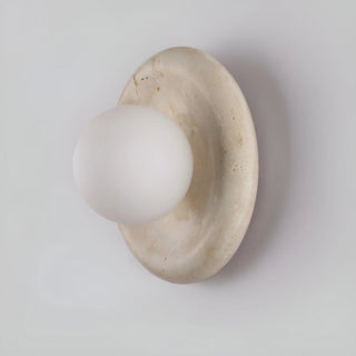 Detailed view of a compact stone wall sconce with a frosted glass globe, showing its clean lines and subtle elegance