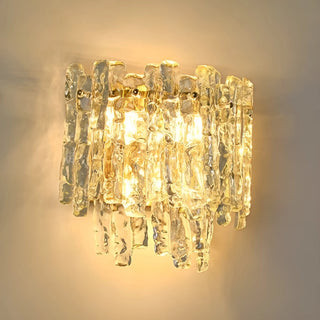 Close-up of illuminated Venezia Murano Glass Wall Sconce casting warm decorative light through textured glass