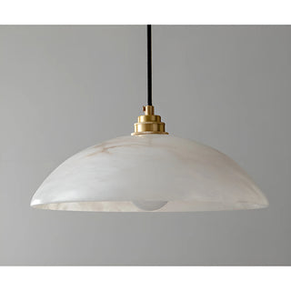 Close-up of Lunara alabaster pendant showing smooth natural stone texture and brushed brass fixture