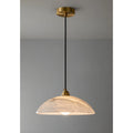 Minimalist Lunara pendant light with alabaster dome shade and brass canopy, perfect for modern interiors