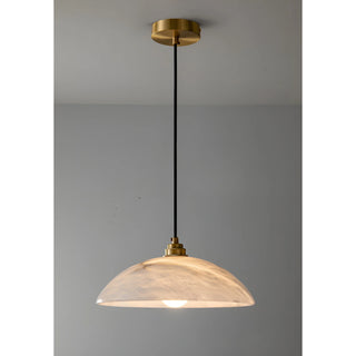 Minimalist Lunara pendant light with alabaster dome shade and brass canopy, perfect for modern interiors