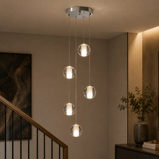 Five-light Lenno crystal bubble-glass globe pendant cluster cascading down a modern staircase