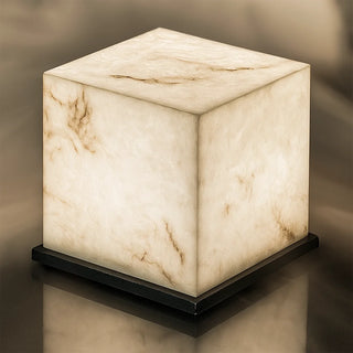 Close-up of a marble cube outdoor lamp showing detailed natural veining and soft warm illumination