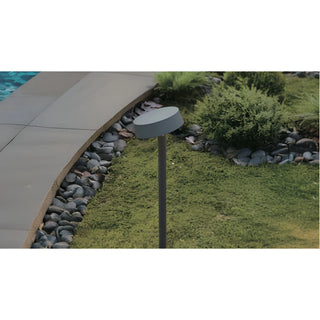 Minimalist outdoor LED path light installed near a garden walkway, blending seamlessly with landscaping