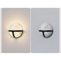 The Nube Marble Waterproof Outdoor Wall Light in two settings: illuminated and off, showing the design and functionality