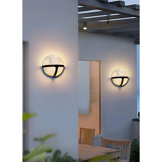 The Nube Marble Waterproof Outdoor Wall Light installed on an exterior wall, illuminating a modern patio area