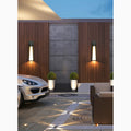 LED wall lights illuminating a stylish driveway entrance with wooden paneling and modern décor.