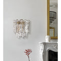 Venezia Murano Glass Wall Sconce in clear textured Murano glass with brass accents mounted on a luxury interior wall