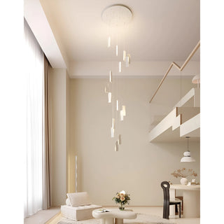 Elegant modern chandelier with wavy LED panels suspended from a high ceiling in a bright loft living room interior